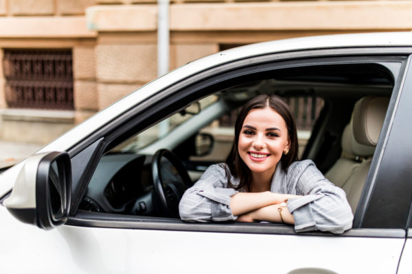 closeup-portrait-happy-smiling-young-attractive-woman-buyer-sitting-her-new-car-excited-ready-trip-isolated-outside-dealer-dealership-lot-office-personal-transportation-auto-purchase-concept